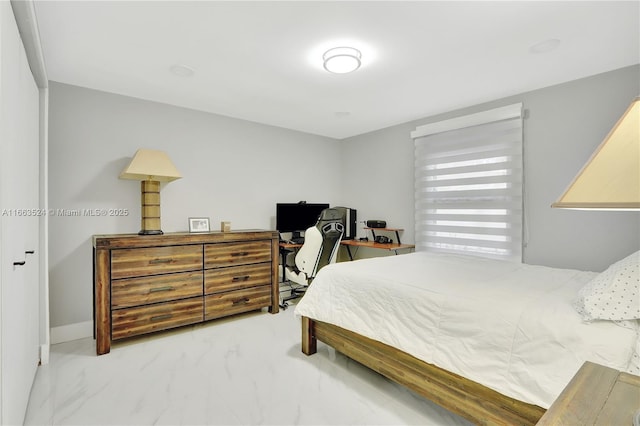 bedroom featuring marble finish floor