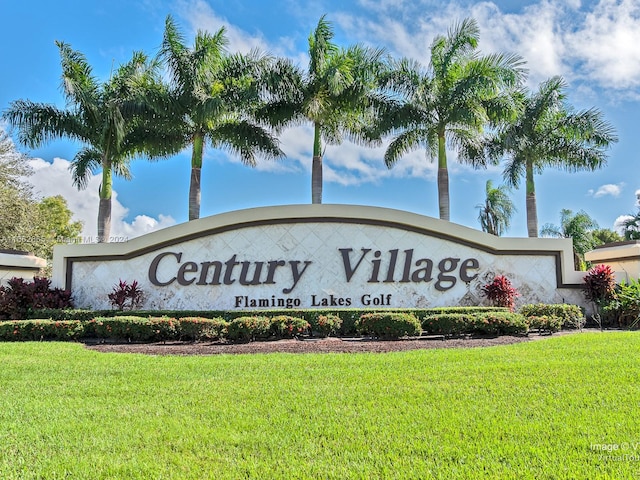 community / neighborhood sign with a yard