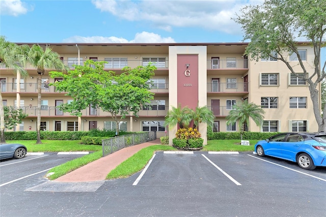 13255 SW 9th Ct Unit 114G, Pembroke Pines, FL 33027 - view of building exterior featuring uncovered parking