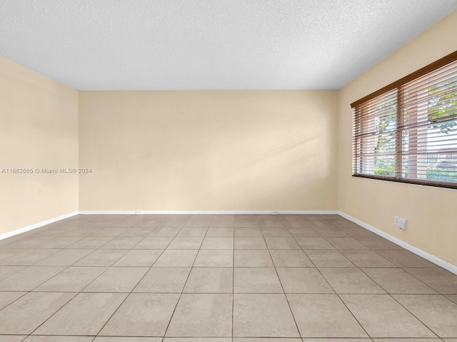 13255 SW 9th Ct Unit 114G, Pembroke Pines, FL 33027 - empty room with light tile patterned floors, baseboards, and a textured ceiling