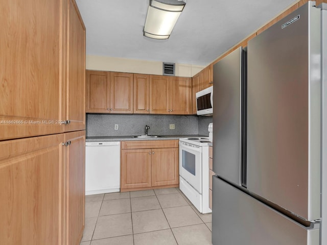 13255 SW 9th Ct Unit 114G, Pembroke Pines, FL 33027 - kitchen featuring light tile patterned floors, white appliances, tasteful backsplash, visible vents, and a sink