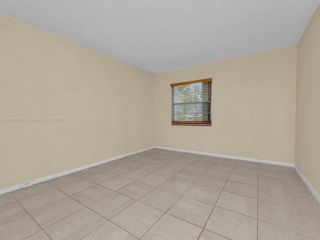 13255 SW 9th Ct Unit 114G, Pembroke Pines, FL 33027 - empty room featuring a textured ceiling and baseboards