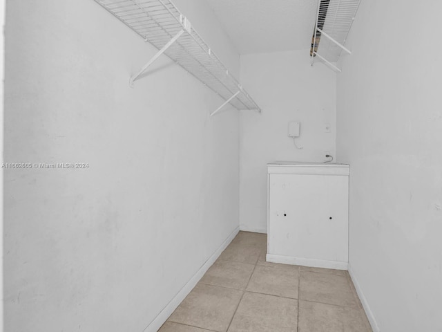 spacious closet featuring light tile patterned floors