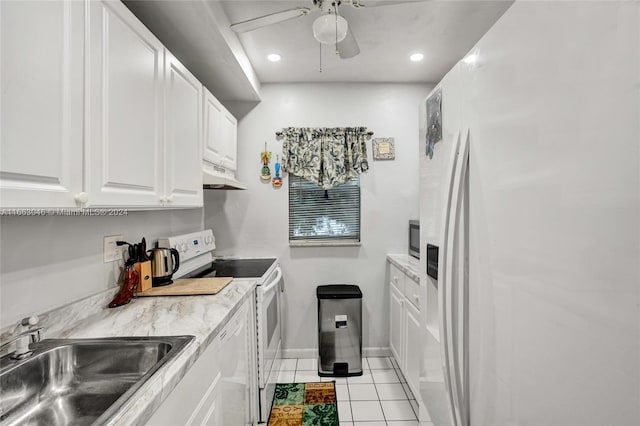 kitchen with white appliances, sink, ceiling fan, light tile patterned floors, and white cabinetry