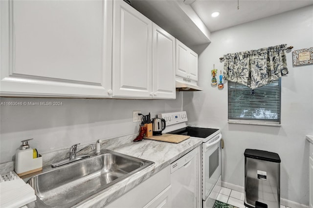 kitchen with white cabinets, light tile patterned floors, white appliances, and sink