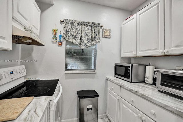 kitchen featuring white electric range oven, white cabinetry, and light stone countertops