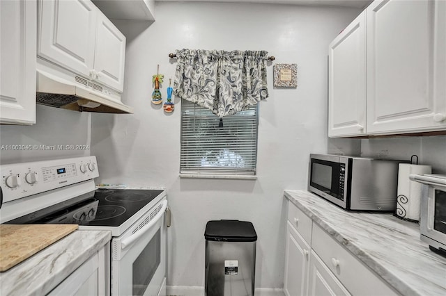 kitchen with white cabinetry, white range with electric stovetop, and light stone counters