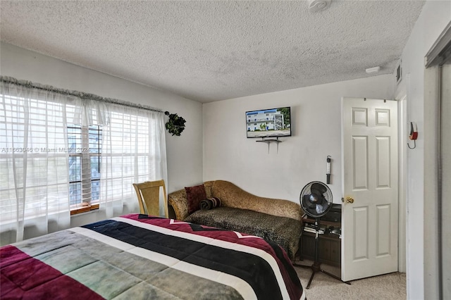 bedroom with light carpet, a textured ceiling, and vaulted ceiling