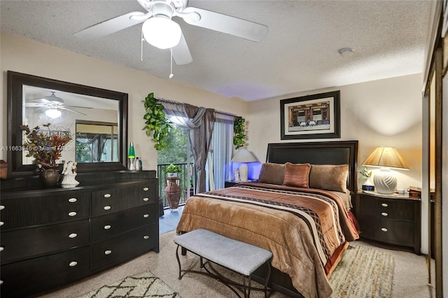 bedroom featuring access to exterior, a textured ceiling, and ceiling fan