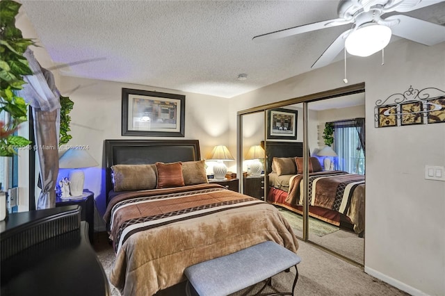 carpeted bedroom with a textured ceiling, a closet, and ceiling fan