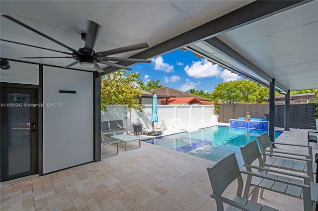 view of pool featuring pool water feature, ceiling fan, and a patio area