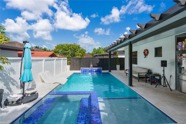 view of pool featuring pool water feature and a patio area