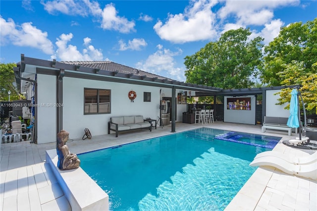 view of pool with outdoor lounge area and a patio area