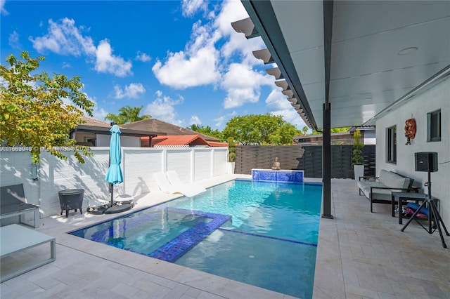 view of pool with pool water feature and a patio