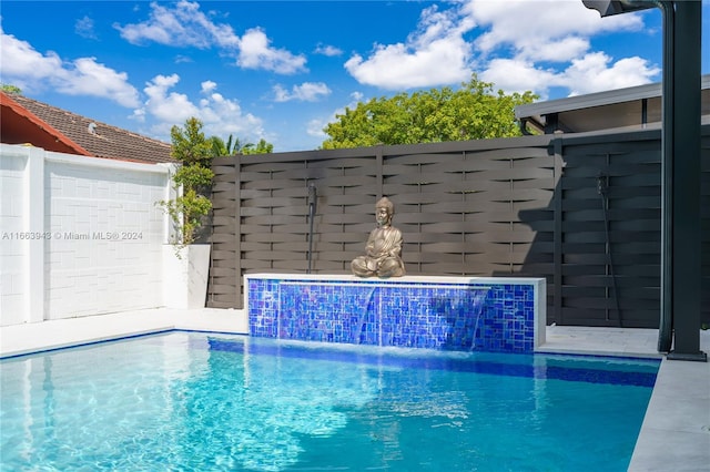 view of swimming pool featuring pool water feature