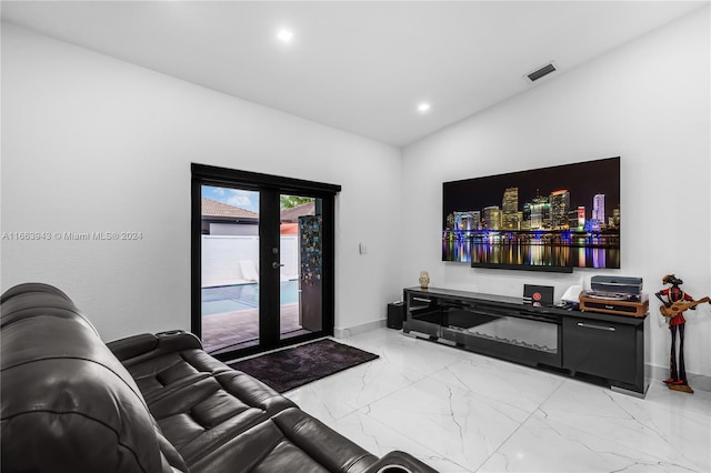 living room featuring french doors and lofted ceiling