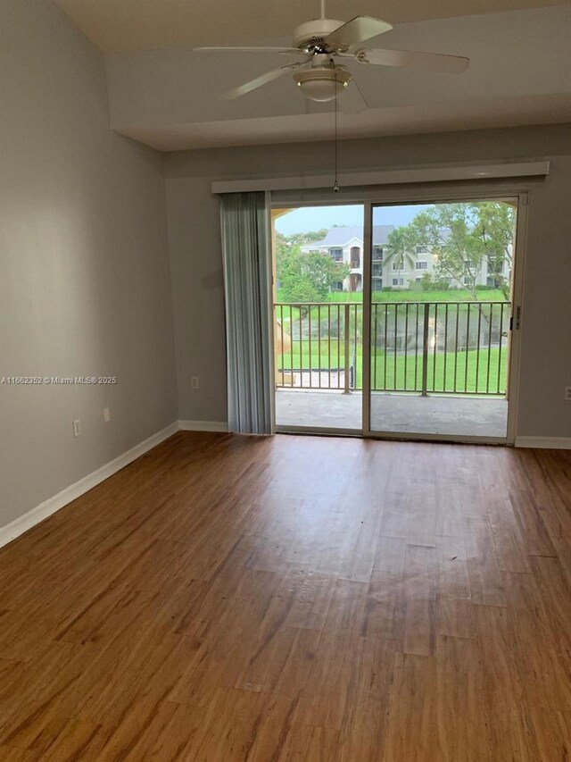 unfurnished room with ceiling fan and hardwood / wood-style flooring