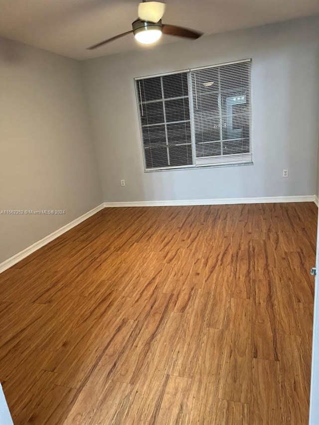 unfurnished room with ceiling fan and wood-type flooring