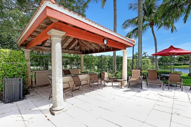 view of patio featuring a water view and a gazebo