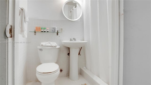 bathroom featuring tile walls, walk in shower, and toilet