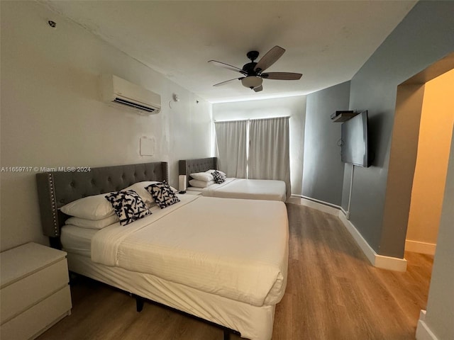 bedroom featuring wood-type flooring, ceiling fan, and a wall mounted AC