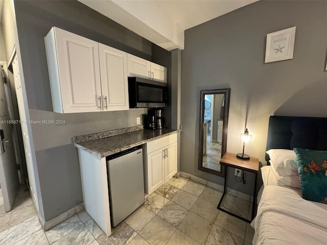 kitchen featuring stainless steel appliances and white cabinetry