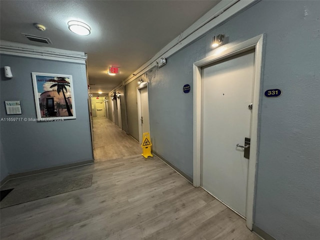 hall with light hardwood / wood-style flooring