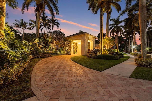 property exterior at dusk with stucco siding