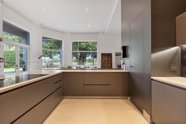 kitchen featuring tasteful backsplash, sink, gray cabinets, and stainless steel oven