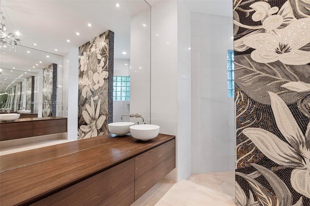 bathroom featuring tile walls, vanity, and a chandelier