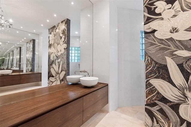 bathroom featuring a notable chandelier and vanity