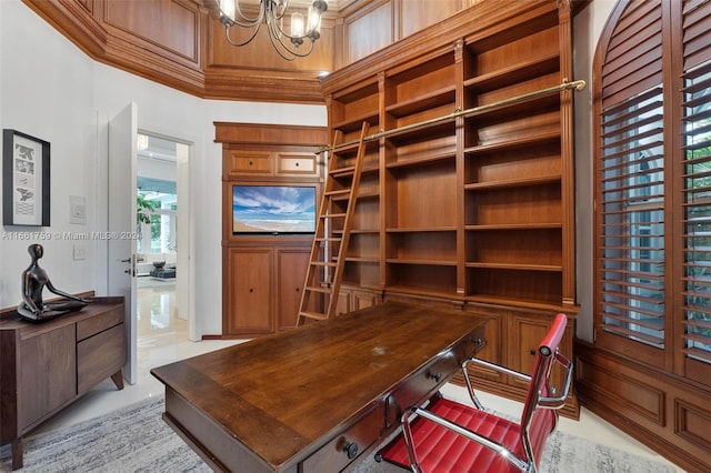 home office with ornamental molding and an inviting chandelier