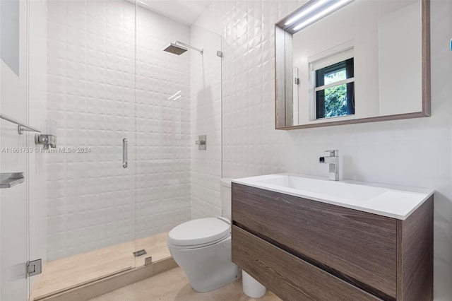 bathroom with walk in shower, vanity, and toilet