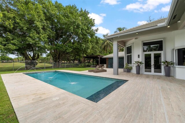 view of pool with a lawn and a patio