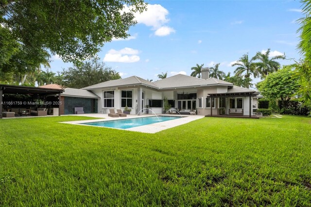 back of property featuring french doors, a yard, a wooden deck, and a pergola