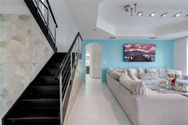 living room with tile walls and light tile patterned floors