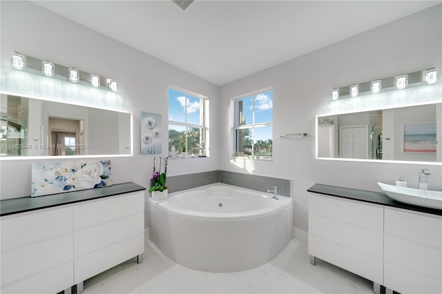 bathroom with vanity and shower with separate bathtub