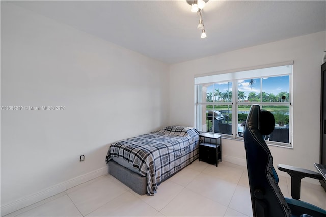 bedroom with light tile patterned floors