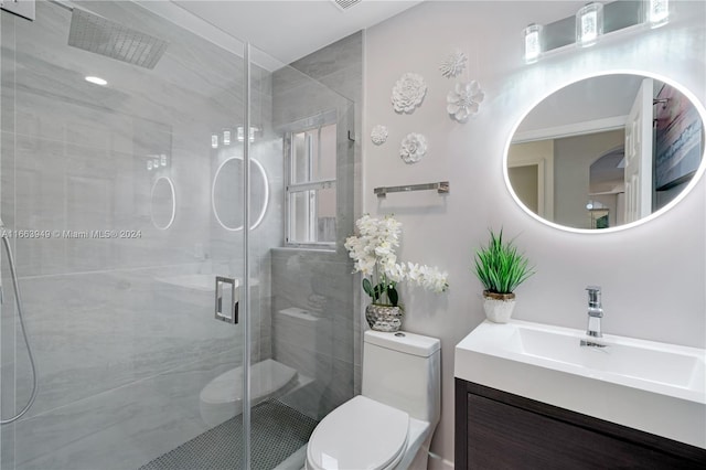 bathroom with an enclosed shower, vanity, and toilet