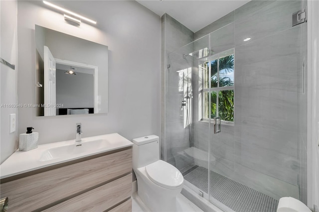 bathroom with vanity, toilet, and an enclosed shower