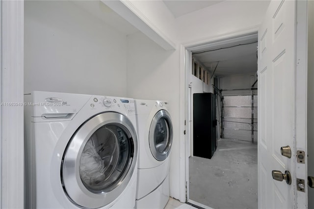 clothes washing area with washing machine and dryer