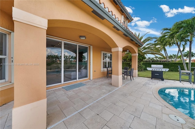 view of patio / terrace featuring a fenced in pool and a grill