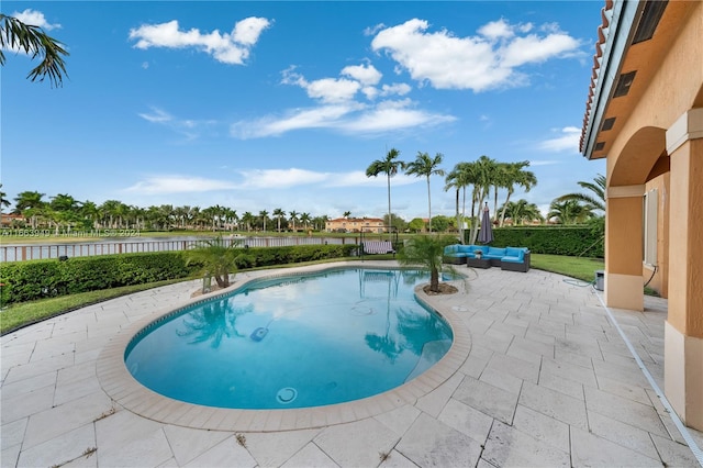 view of pool featuring a water view and a patio area