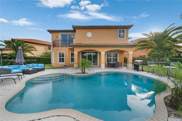 view of pool featuring an outdoor living space, a grill, and a patio area