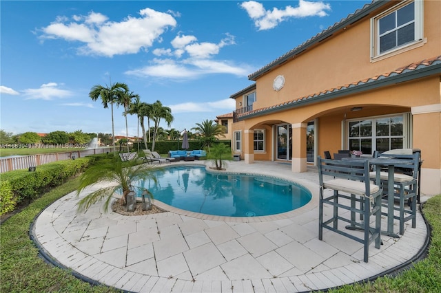 view of swimming pool with outdoor lounge area and a patio