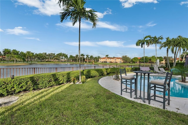 view of yard featuring a patio, a water view, and a fenced in pool