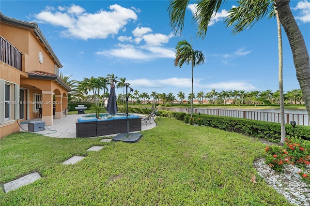 view of yard with a patio and a water view