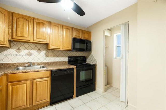 kitchen featuring sink, decorative backsplash, and black appliances