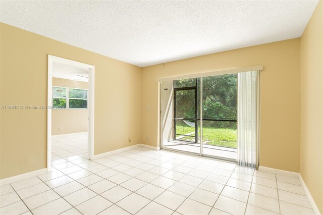 tiled empty room with ceiling fan