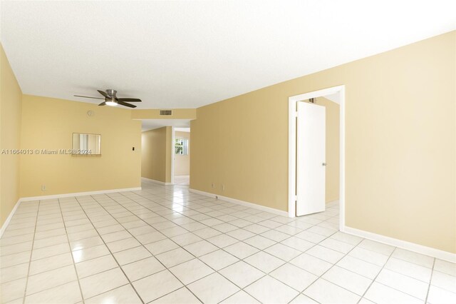 unfurnished room featuring ceiling fan and light tile patterned floors